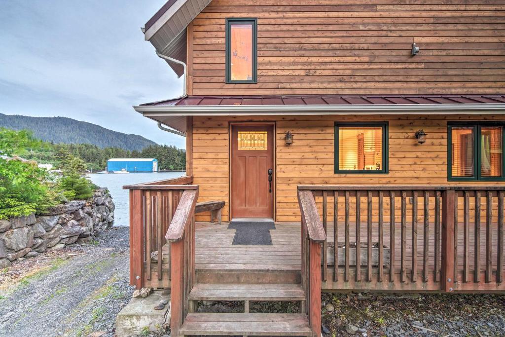 a wooden house with a wooden porch and a door at Ketchikan Apt - Walk to Refuge Cove Beach! in Ketchikan