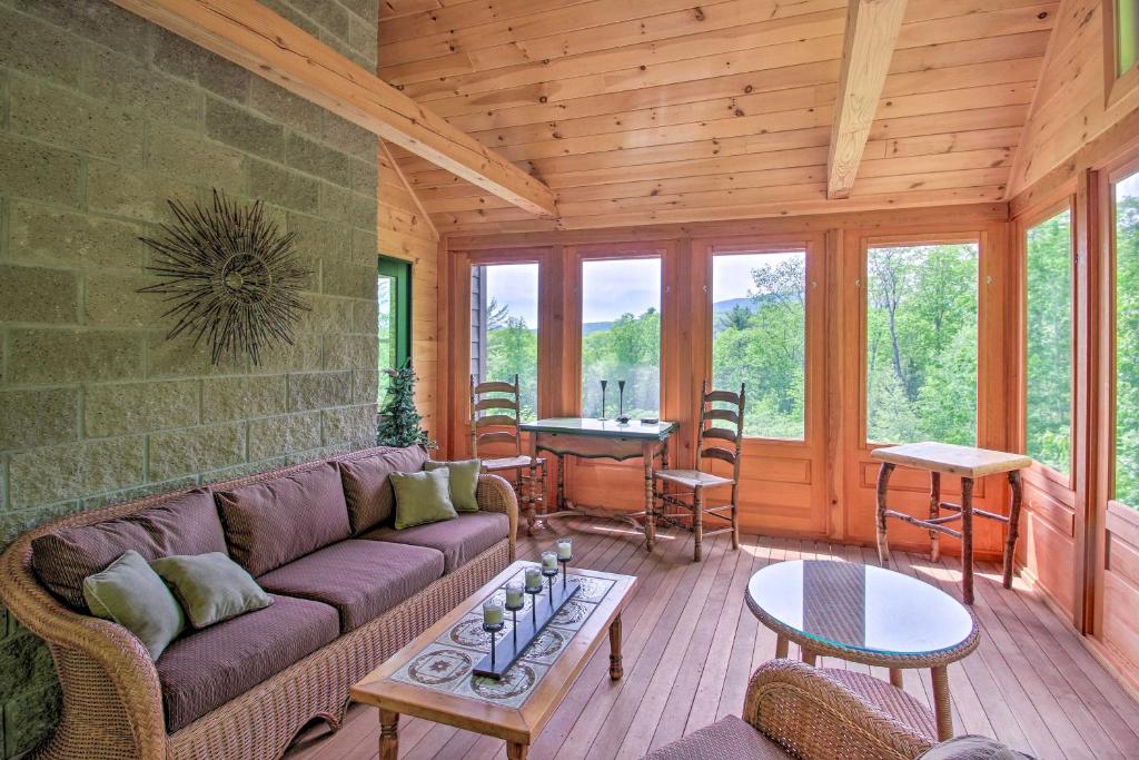 a living room with a couch and a table at Home with Fire Pit, 7 Mi to Attitash Mtn Resort in Jackson