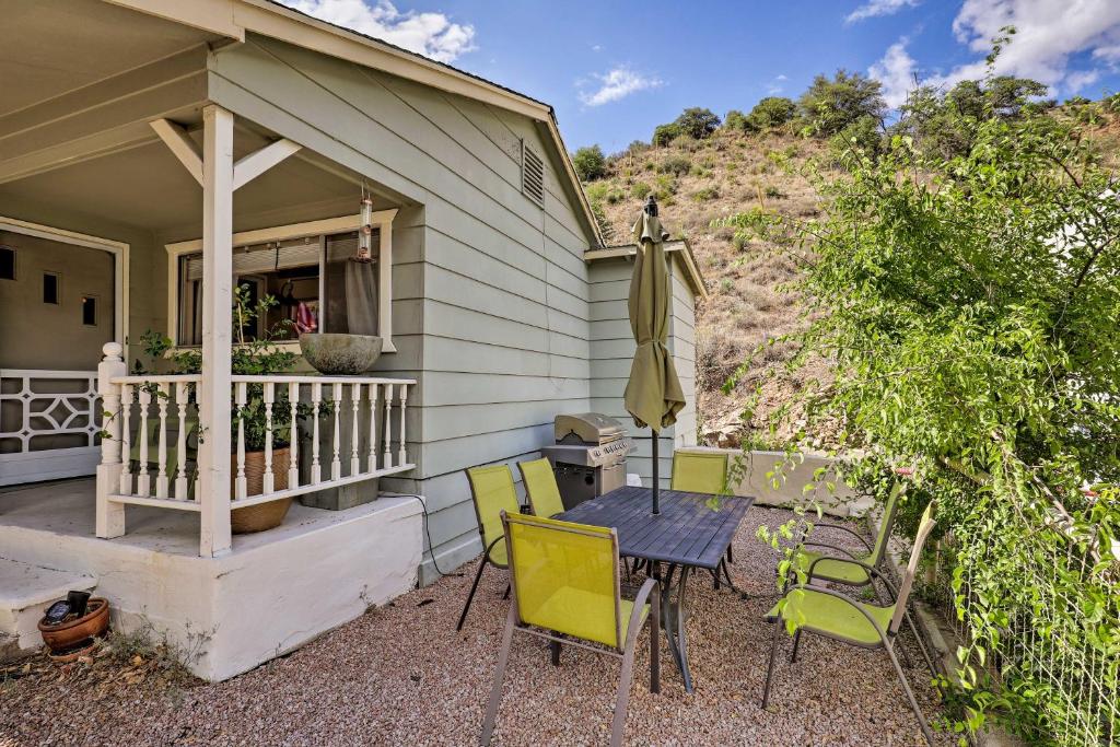 a patio with a table and chairs and an umbrella at Bisbee Home with Private Parking and EV Charger! in Bisbee