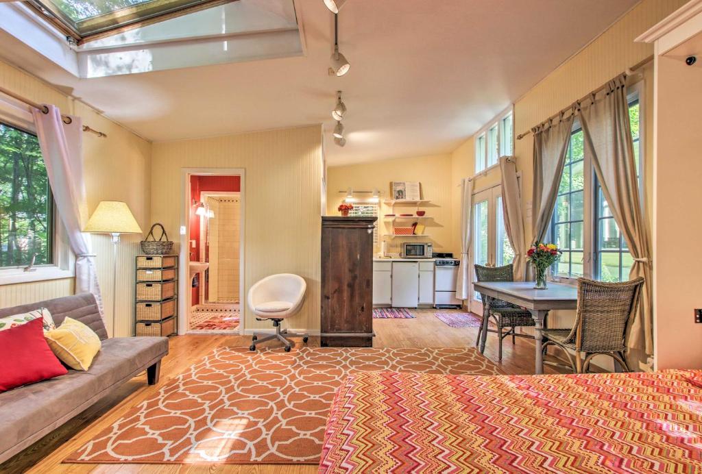 a living room with a bed and a table at Quiet Saugatuck Studio with Patio - Walk to Dtwn! in Saugatuck
