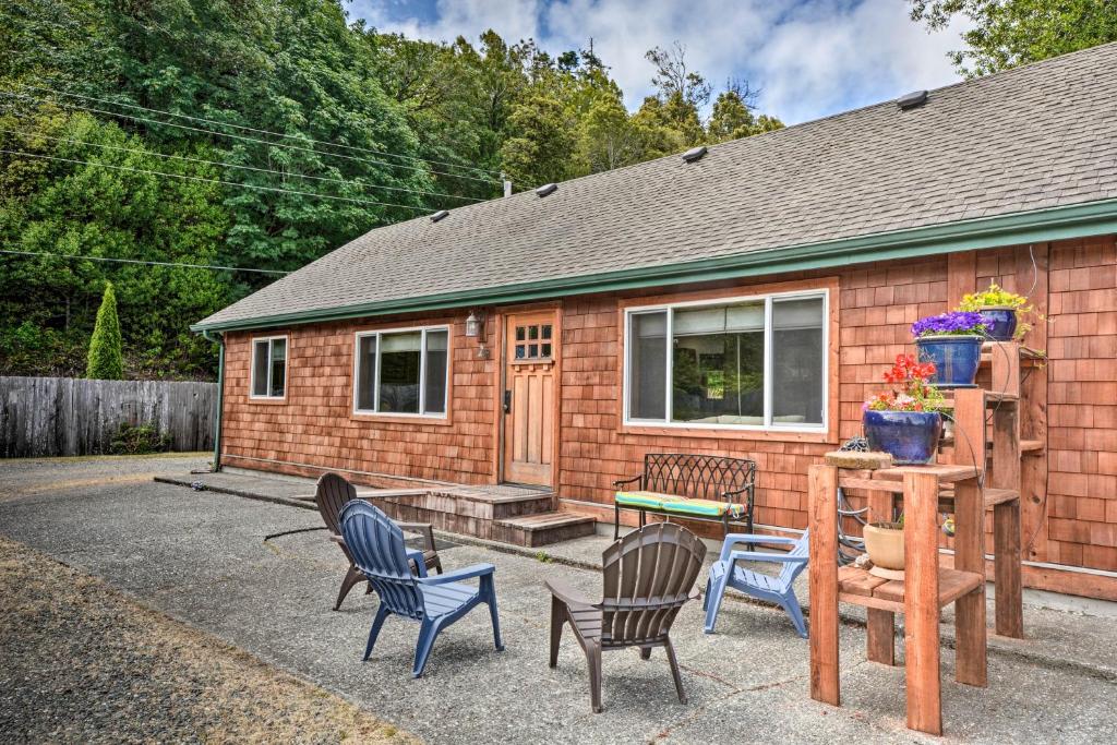 a house with chairs and a table and a house at Gold Beach Apartment with Activities - 2 Mi to Ocean in Gold Beach