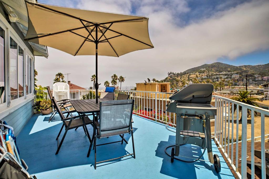a bbq on a balcony with a grill and an umbrella at Ocean-View Home - Walk to Avalon City Center! in Avalon