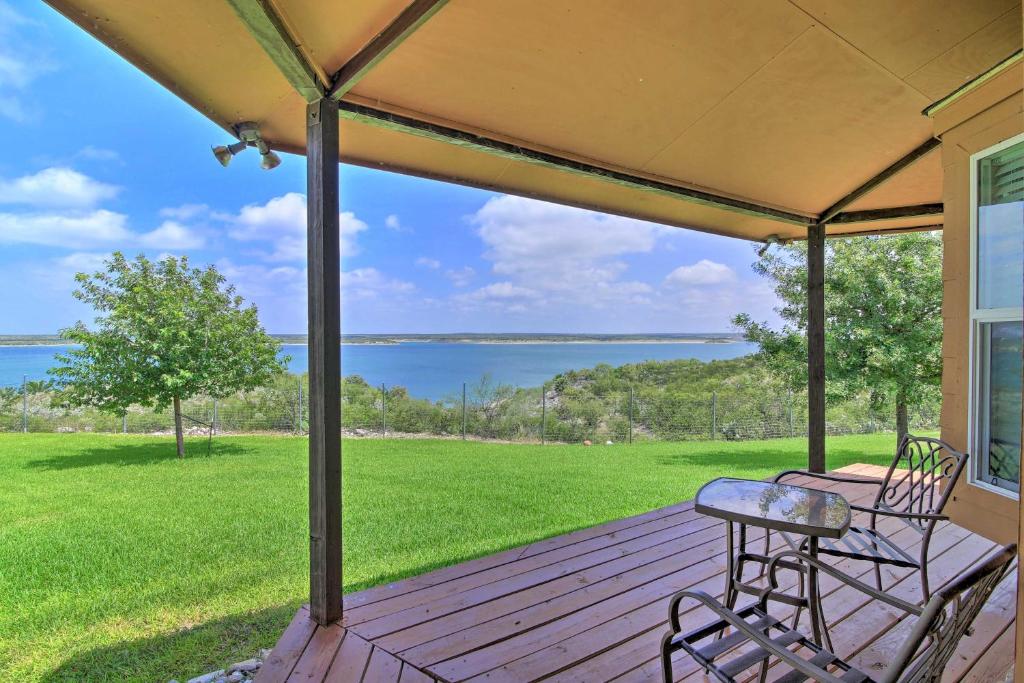 a porch with a table and chairs and a view of the water at Del Rio Home with Lake Access and Boat Storage! in Del Rio