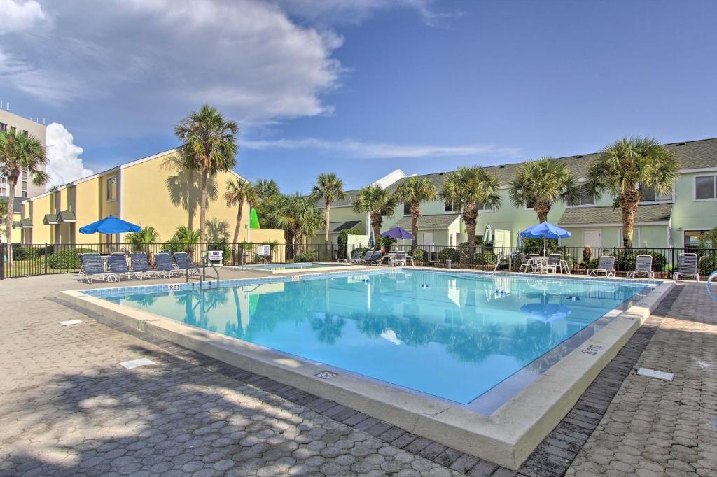 a swimming pool at a resort with chairs and umbrellas at Destin Townhome with Beach Access & 2 Pools! in Destin