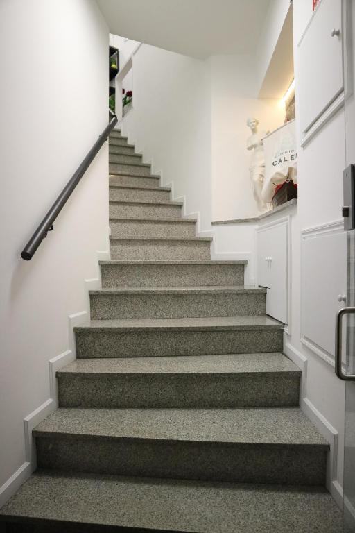 a staircase in a house with grey carpet at Guest House Triunfo in Porto