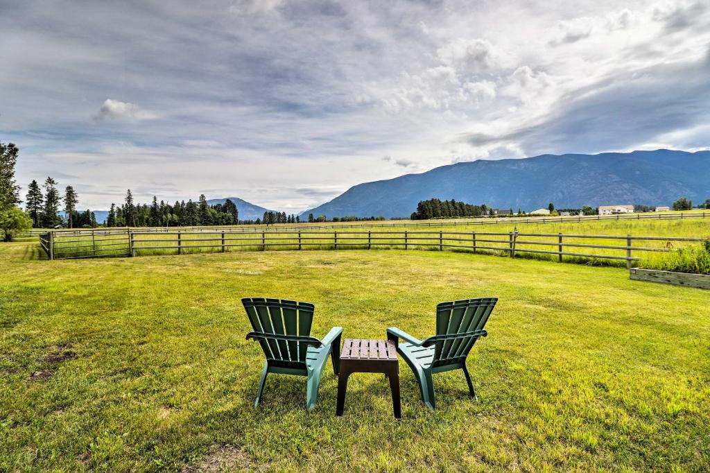 two chairs and a table in the middle of a field at Columbia Falls Home 19 Mi to Glacier National Park in Columbia Falls