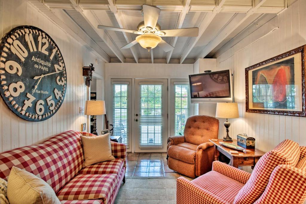 a living room with two couches and a clock on the wall at Altamonte Springs Home with Canoe on Lake Marion in Orlando