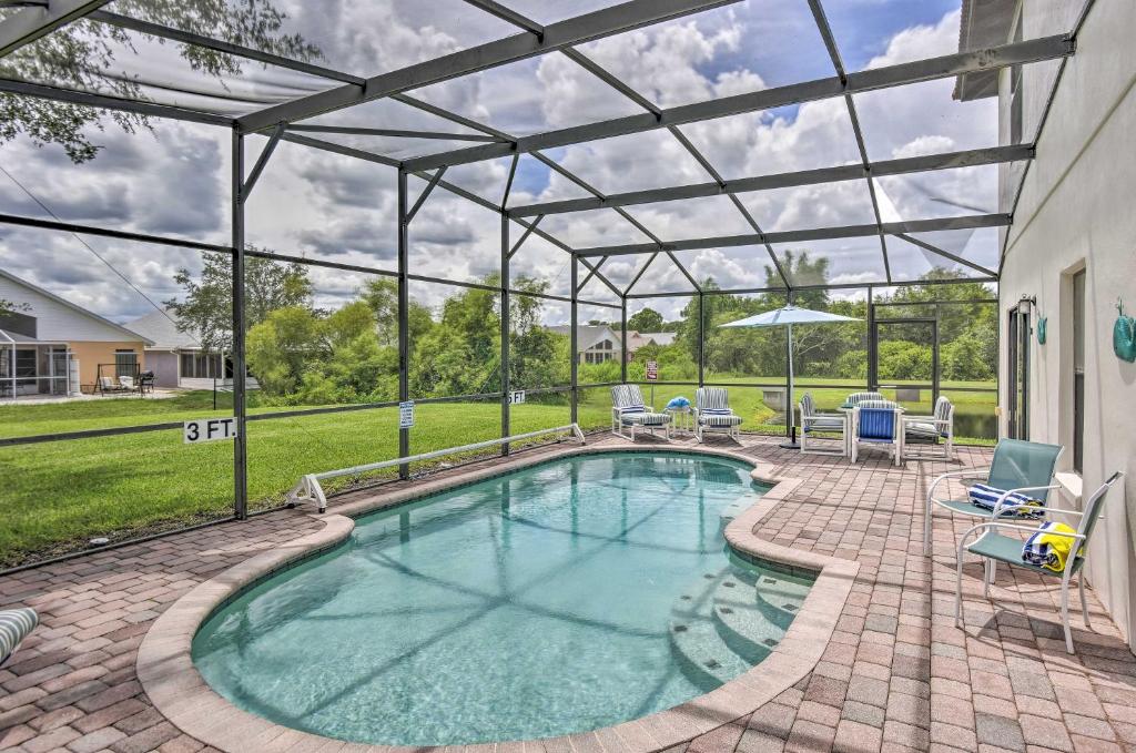 a swimming pool with a pergola next to a house at Disney Villa with Game Room and Pool - 10 Mi to Parks! in Orlando