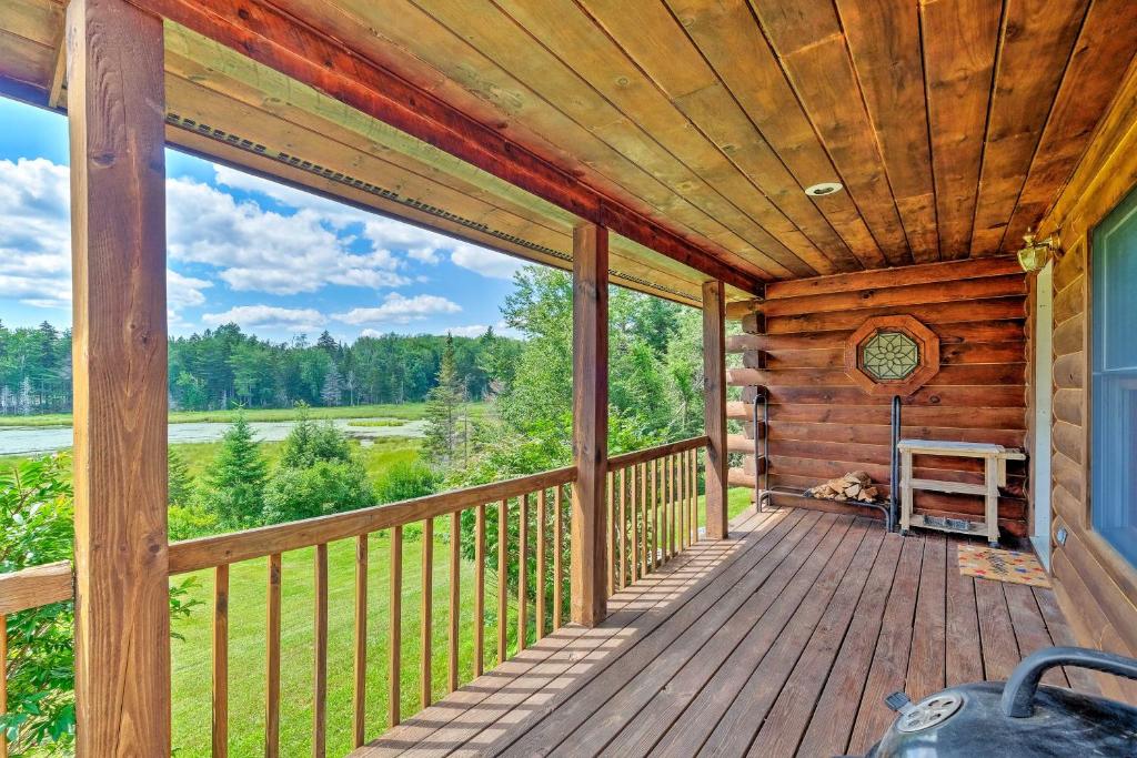 a porch of a log cabin with a wooden ceiling at Jacksonville Cabin with Wraparound Deck and Views in Jacksonville