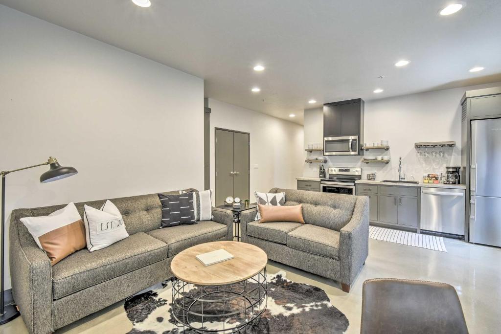 a living room with a couch and a table at Elkhart Lake Townhome - 20 Mi to Sheboygan! in Elkhart Lake