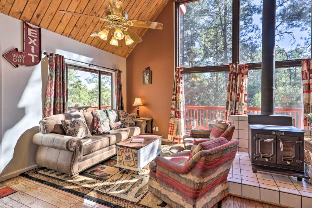 a living room with a couch and a fireplace at Prescott Cabin with Gas Grill about 10 Min To Downtown! in Prescott