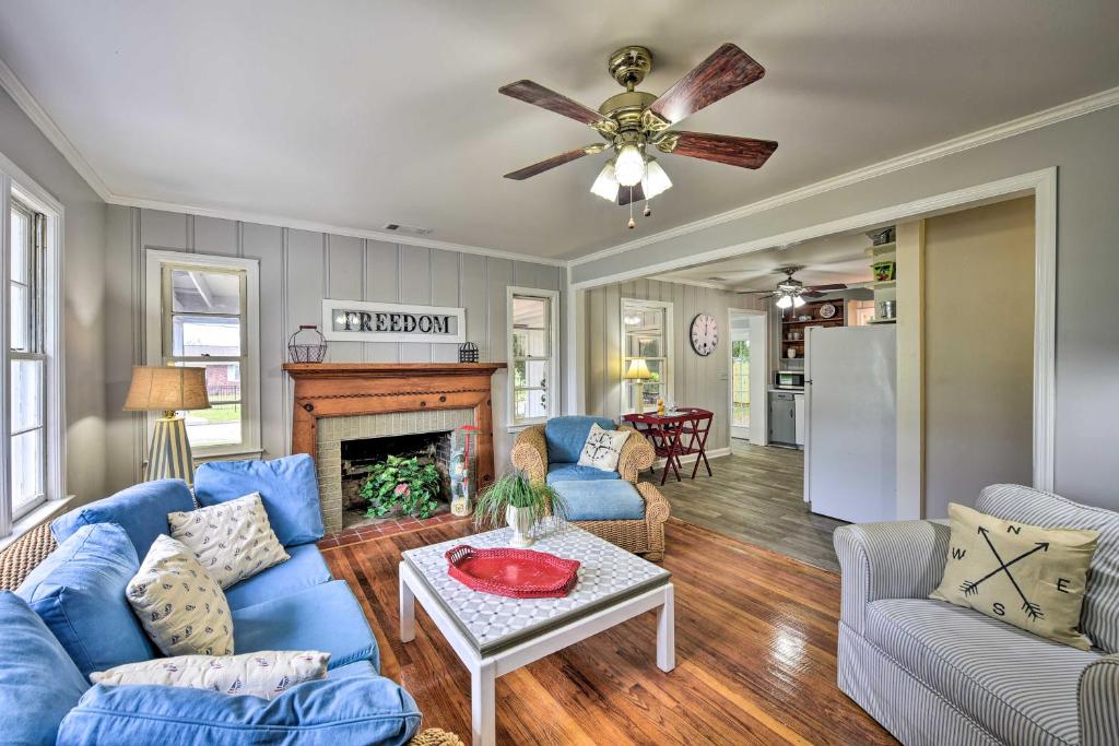 a living room with blue couches and a fireplace at Beaufort Home with Porch, 4 Mi from Downtown! in Beaufort
