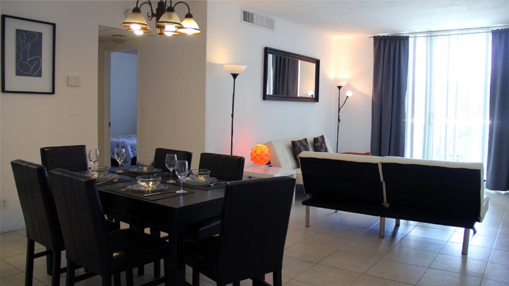 a dining room with a black table and chairs at THE TIDES on MIAMI HOLLYWOOD in Hollywood