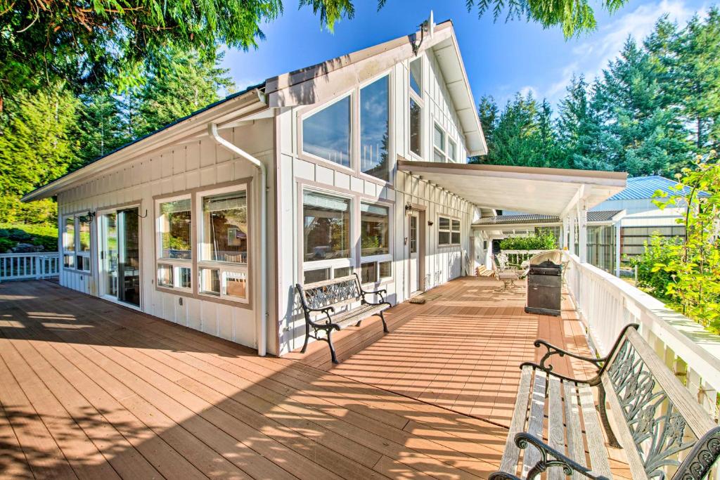 a house with two benches on a wooden deck at Hood Canal Home with Hot Tub - Bordering Olympic NP! in Brinnon