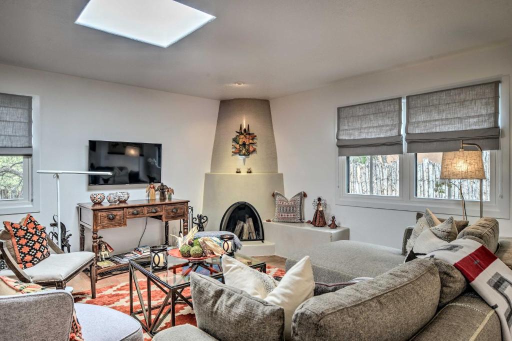 a living room with two couches and a fireplace at Modern Bungalow with Santa Fe Charm Less Than 2 Mi to Plaza in Santa Fe