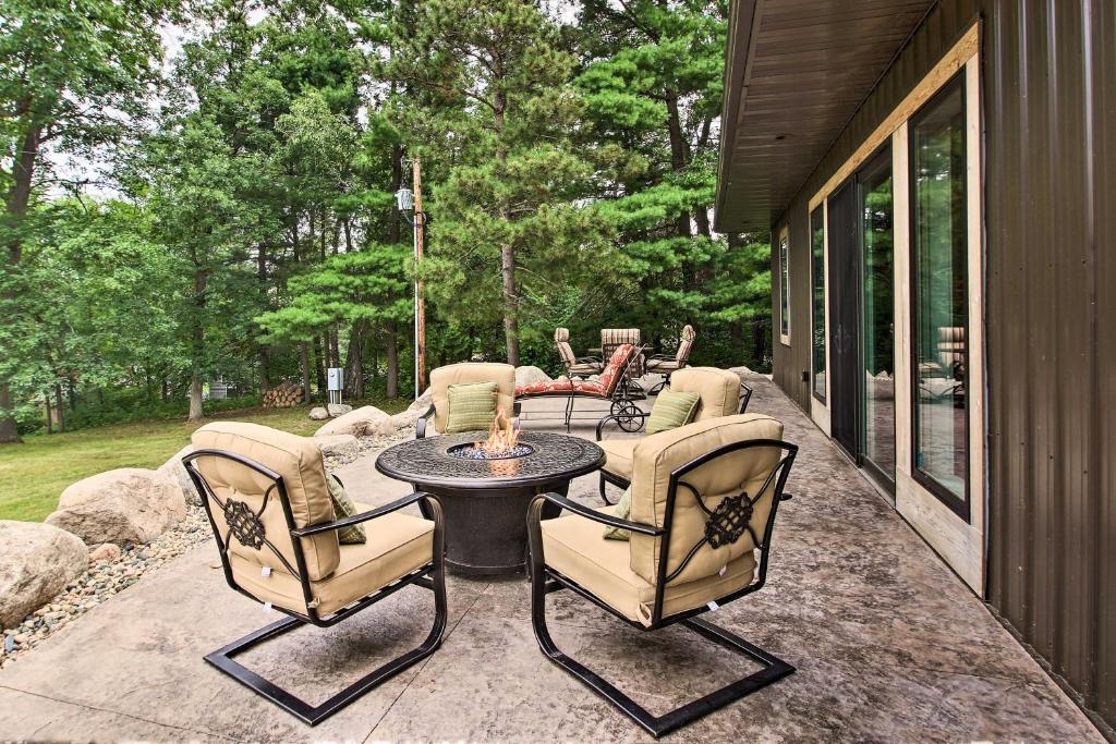 a patio with a table and chairs on a porch at Lakefront Home with Private Dock-15 Mi to Walker in Walker