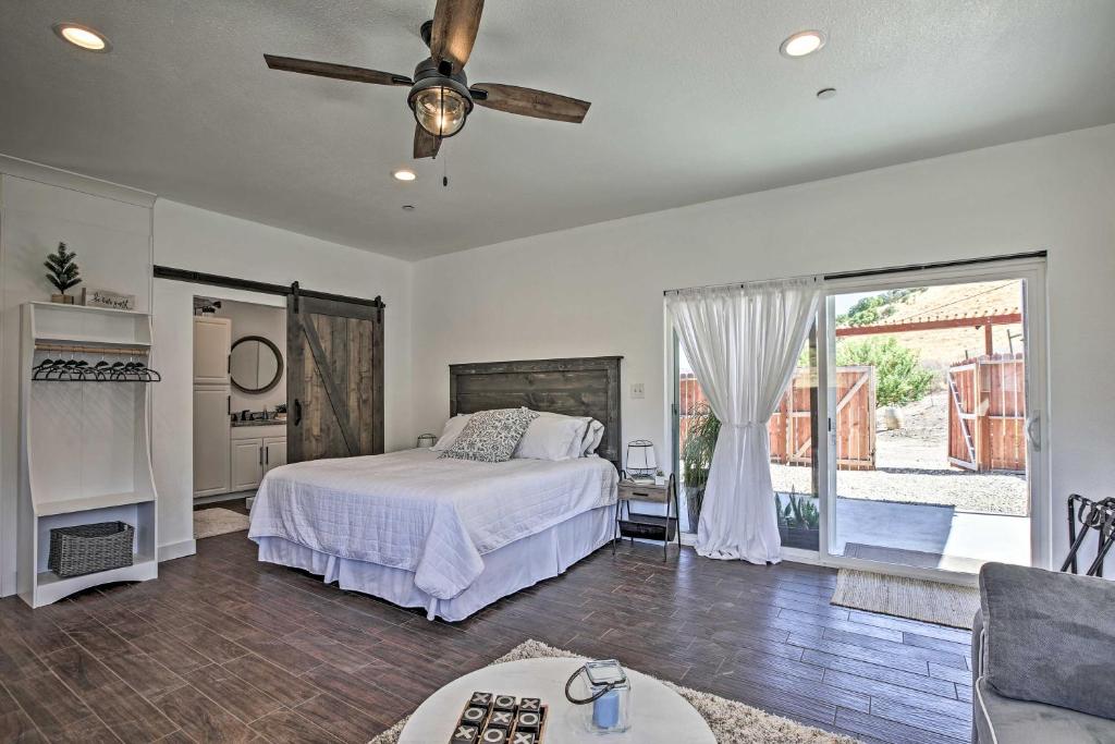 a bedroom with a bed and a ceiling fan at Cottage by the Lakes with Hot Tub by Lake Nacimiento in Oak Shores
