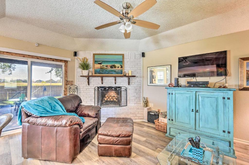 a living room with a couch and a fireplace at Abilene Home with BBQ and Pvt Yard, 1 Mi to ACU! in Abilene