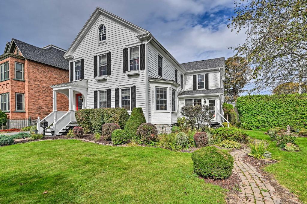 a large white house with a yard at Unique and Historic Home Walk to Lake Champlain in Plattsburgh