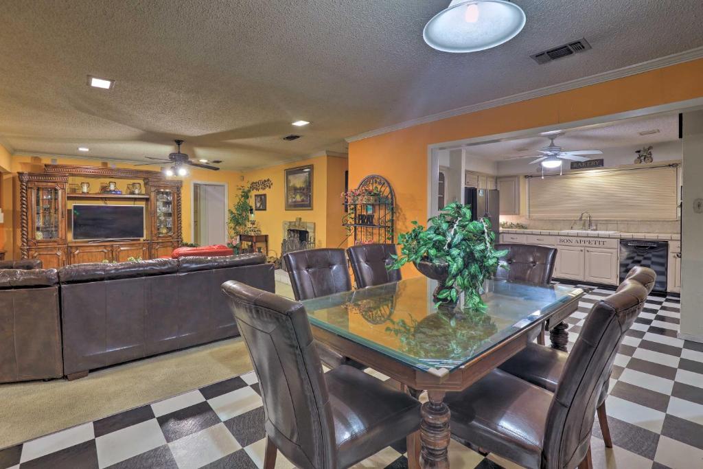 a dining room with a table and leather chairs at Spacious Home with Deck about 2 Mi to Lake Arlington! in Arlington
