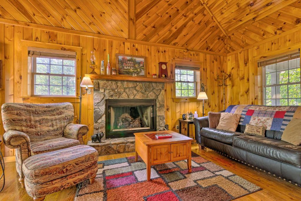 a living room with a couch and a fireplace at 11 Mi to Boone Secluded Pet-Friendly Cabin! in Todd