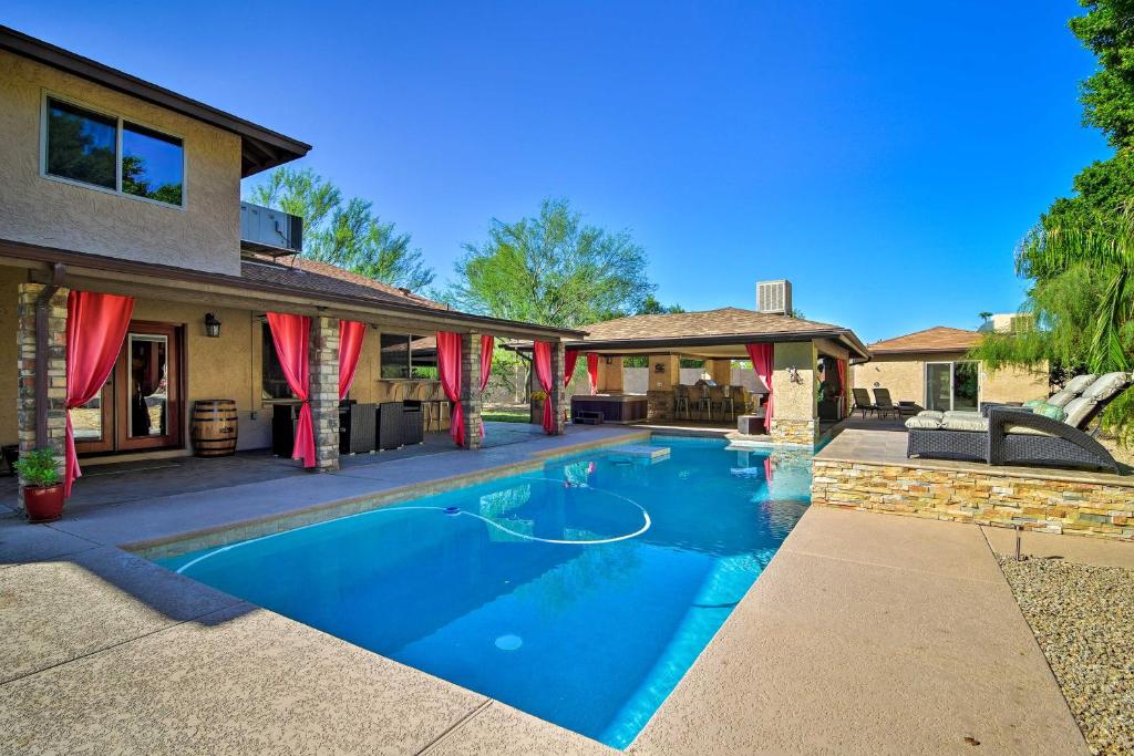 a swimming pool in the backyard of a house at Red Mountain Mesa Oasis Pool, Bar and Game Room! in Mesa