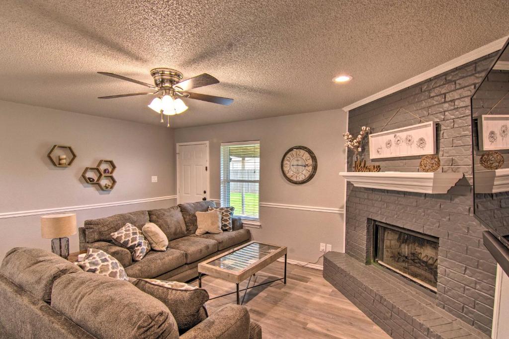 a living room with a couch and a fireplace at Lubbock Home with Backyard - 6 Mi to Texas Tech in Lubbock