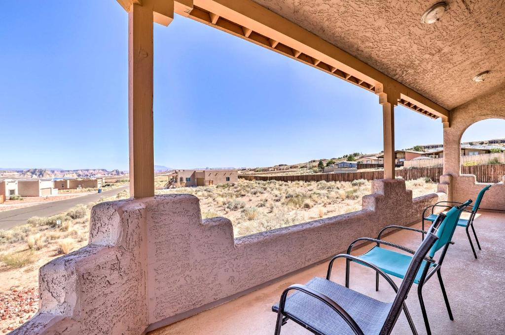 a group of chairs on a porch with a view of the desert at Pet-Friendly Adobe about 3 Miles to Lake Powell! in Wahweap