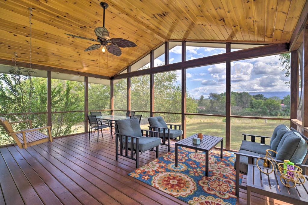 a screened in porch with a table and chairs at JuJus House with Mtn View, 16 Mi to Pigeon Forge! in Seymour