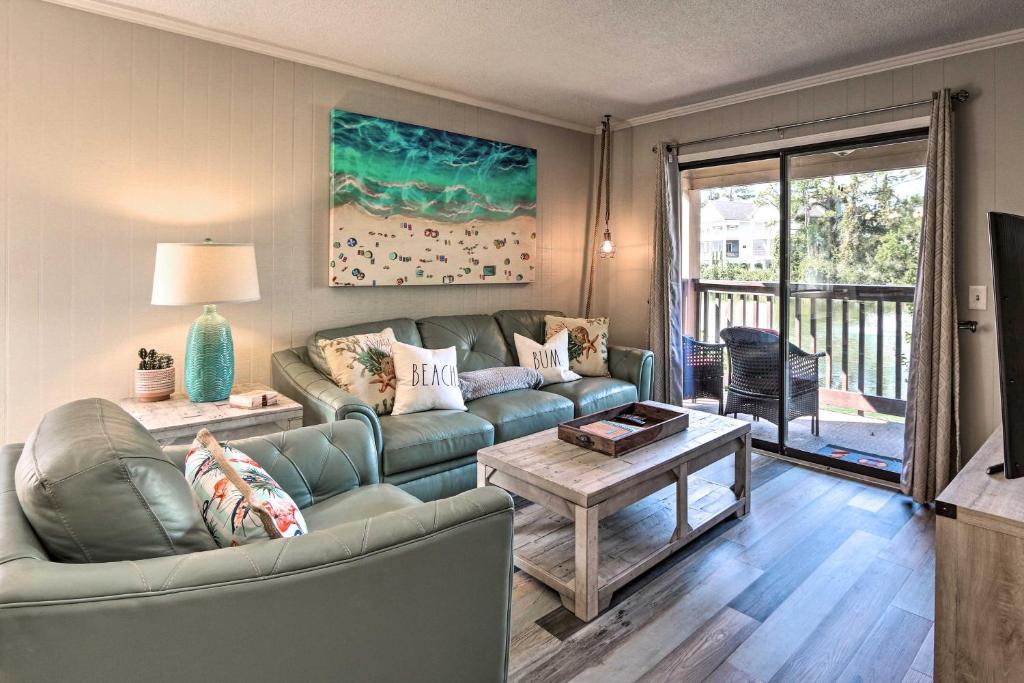 a living room with a couch and a table at Hilton Head Island Condo with Pool and Beach Access in Hilton Head Island