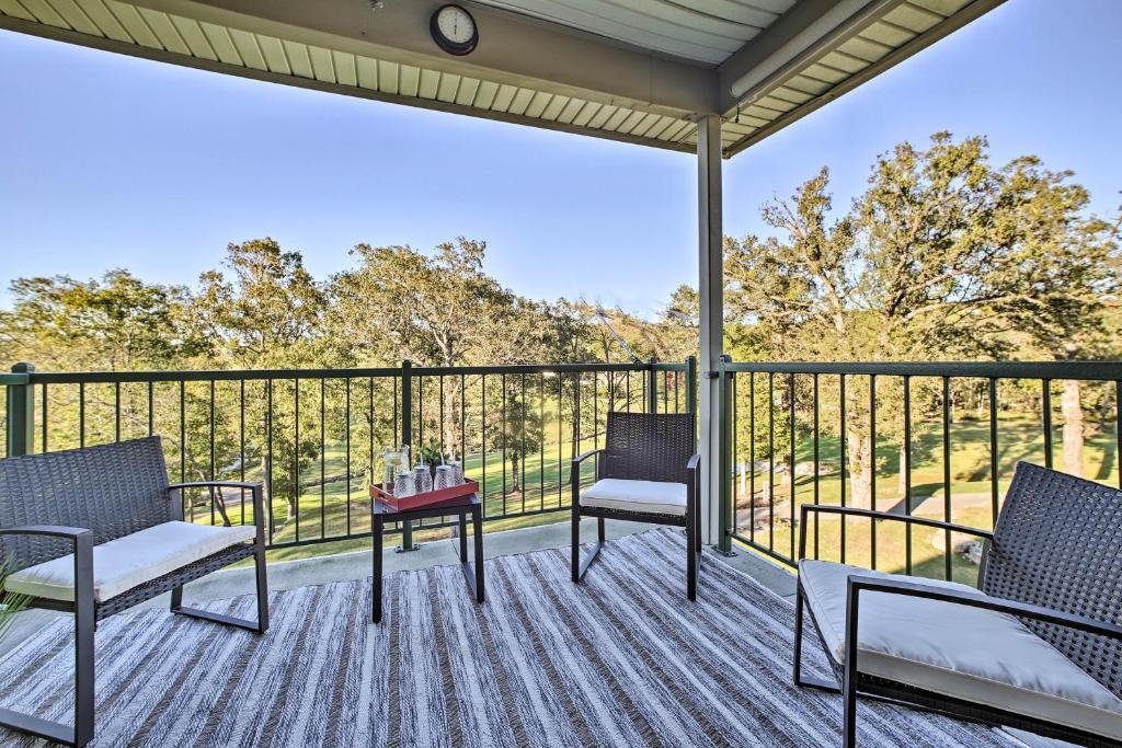 a screened porch with two chairs and a table at The Ridge Branson Condo with Pools and Golf Course! in Branson