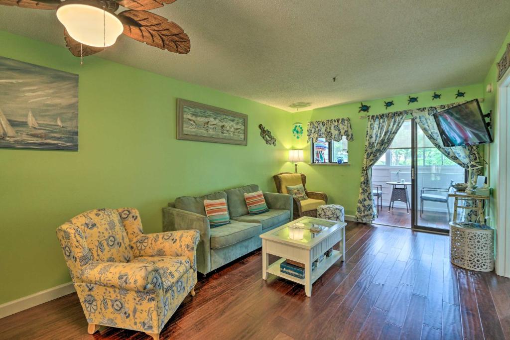 a living room with a couch and a chair at Colorful Resort Condo with Beach and Pool Access! in Hilton Head Island