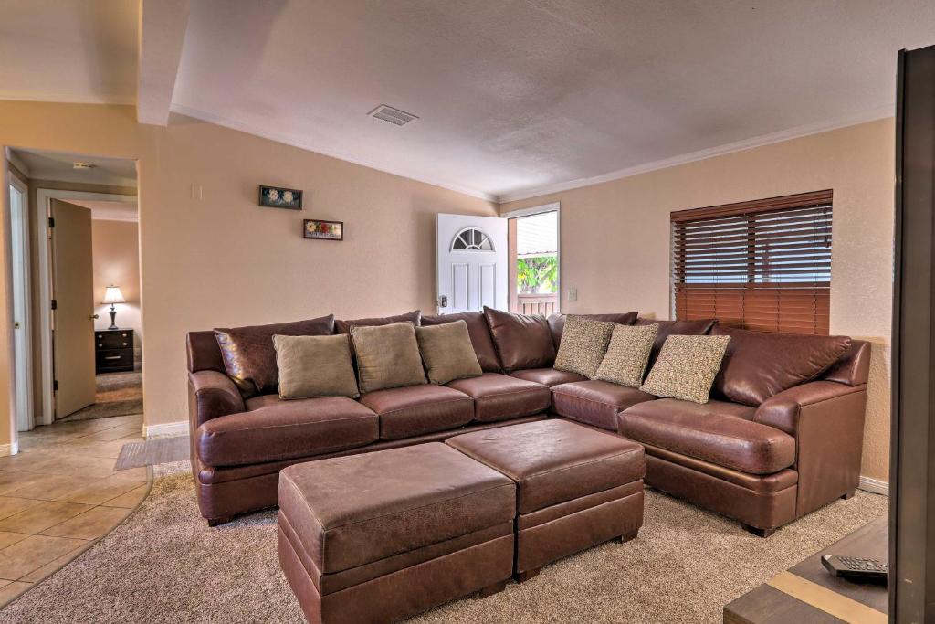 a living room with a brown leather couch at Page Home with Patio and BBQ, 3 Mi to Lake Powell! in Page
