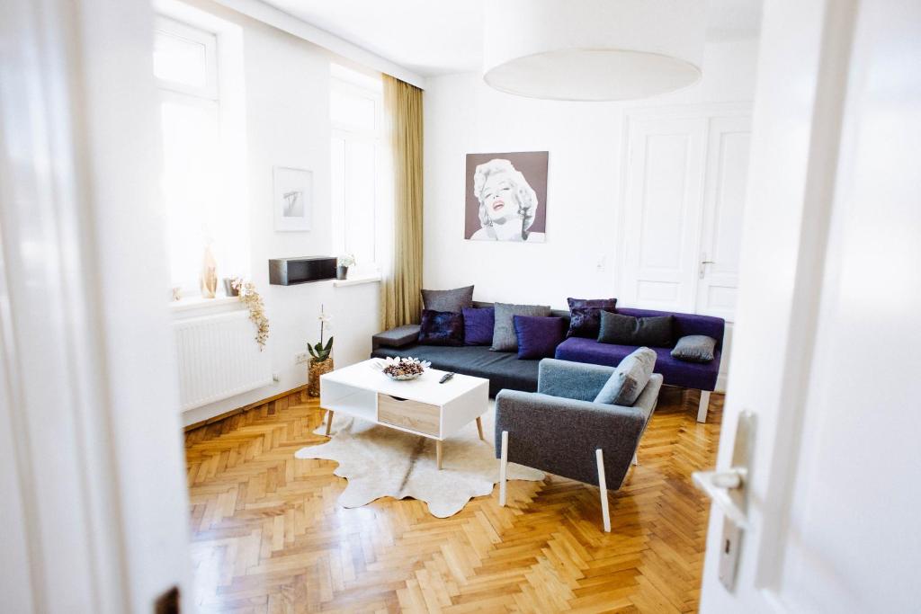 a living room with a couch and a table at Huge Central Designer Loft with Tyrolean Touch , 160m2 in Innsbruck