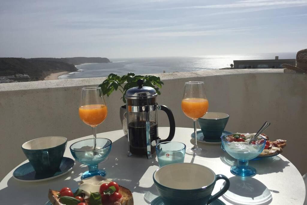 een tafel met een glas sinaasappelsap en wat eten bij Muramaris in Salema