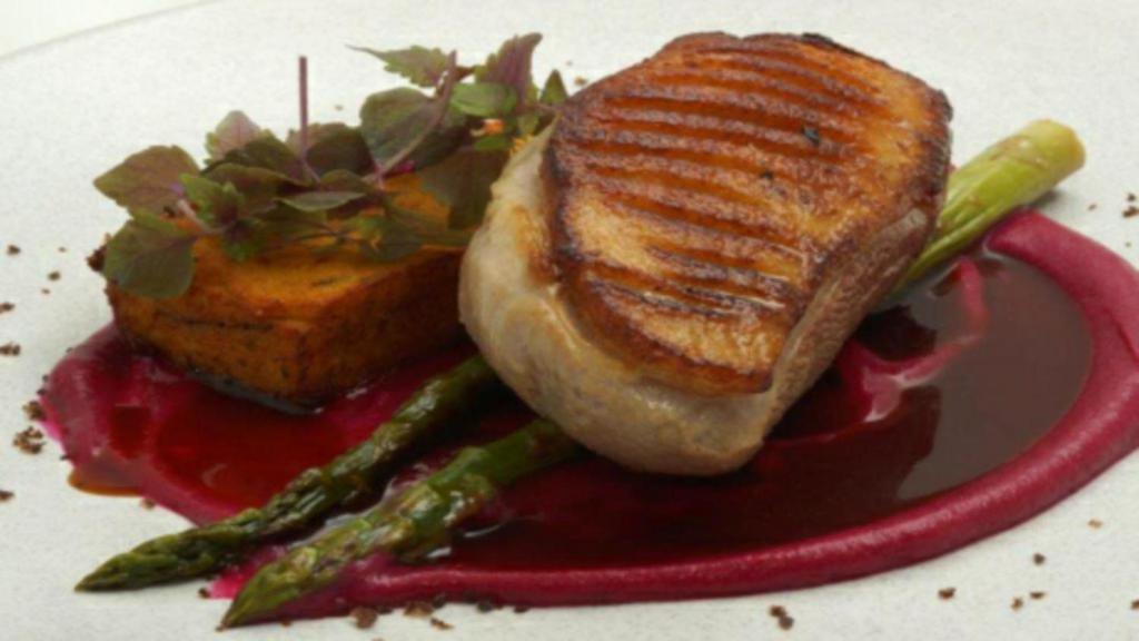 a sandwich with asparagus and sauce on a plate at Hyde Park Inn in Sydney