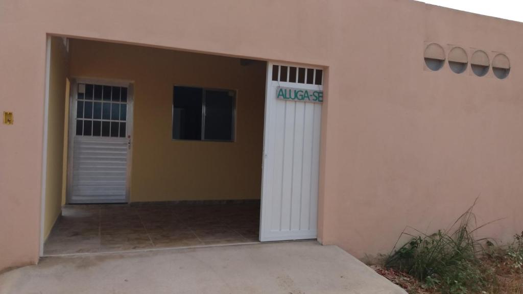 a building with a garage with a sign on it at Casa Morada da Praia 1 in Peroba
