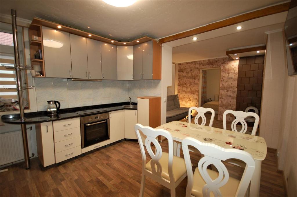 a kitchen with a table and chairs in a kitchen at Ludvika Elegance Apartment in Liepāja