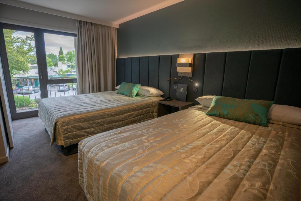 Postel nebo postele na pokoji v ubytování Distinction Luxmore Hotel