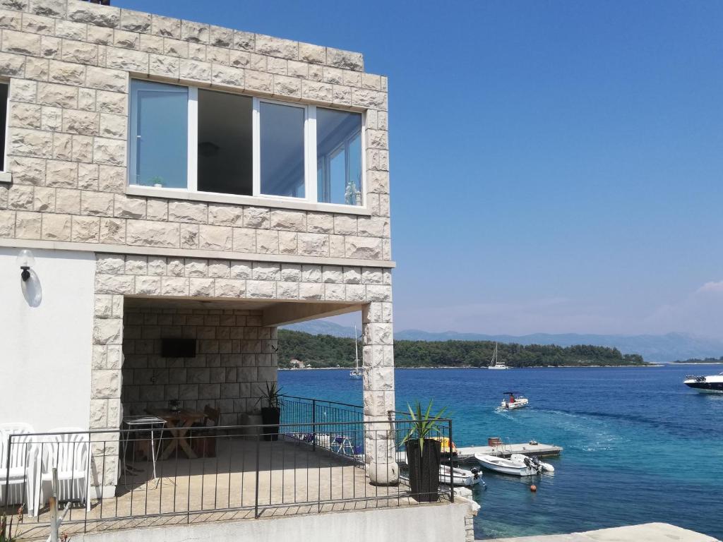 a stone house with a view of the water at Apartment Marne in Lumbarda