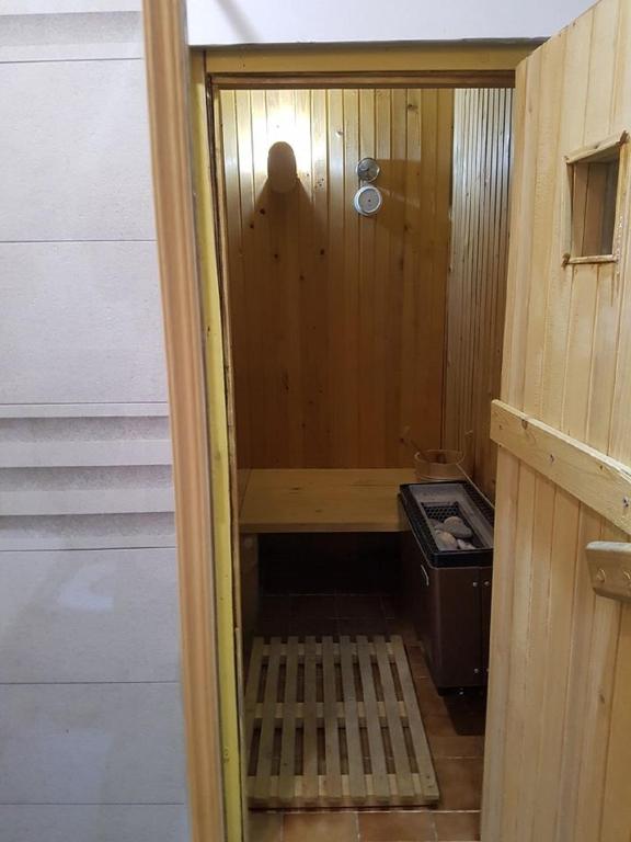 a small bathroom with a shower with a bench in it at Rogla - Chalet Mojca Pokrajculja in Zreče