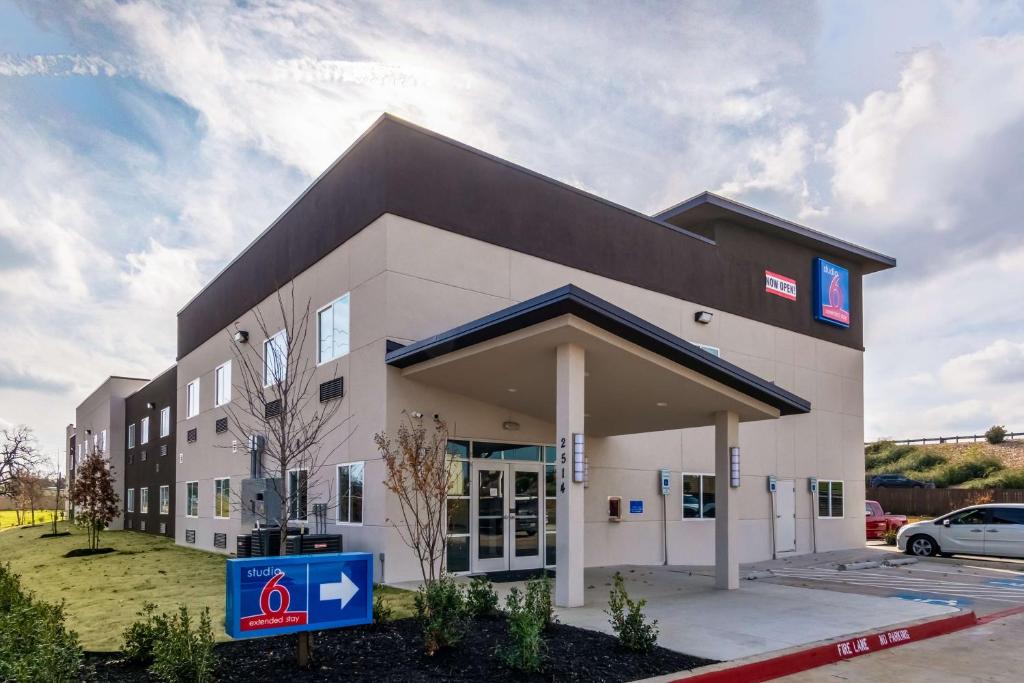 a large building with a sign in front of it at Studio 6-Mesquite, TX - Dallas in Mesquite