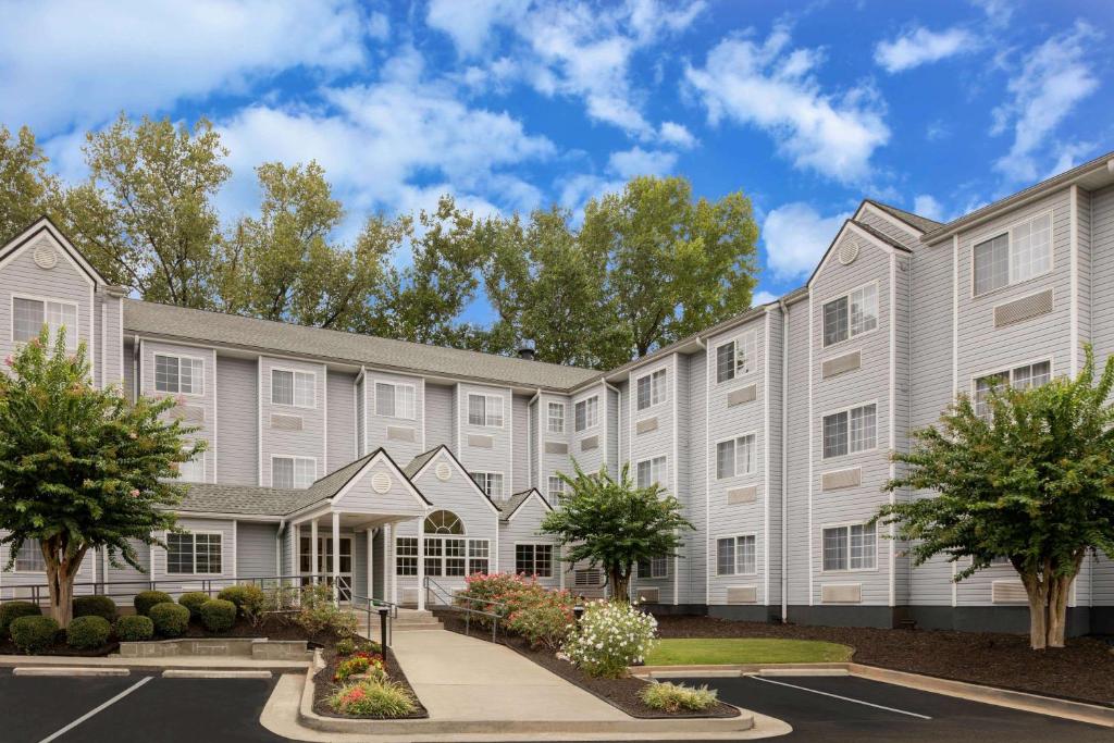 a large apartment building with a parking lot at Microtel Inn & Suites by Wyndham Atlanta Buckhead Area in Atlanta