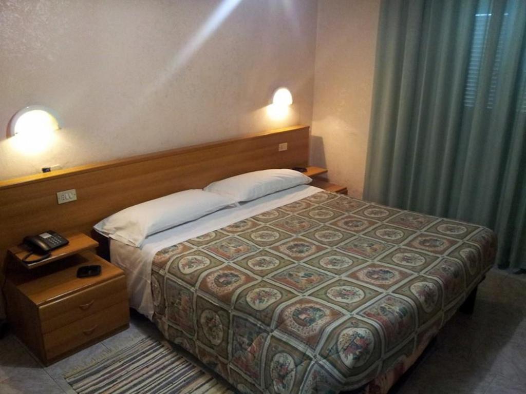 Un pat sau paturi într-o cameră la Hotel Acapulco