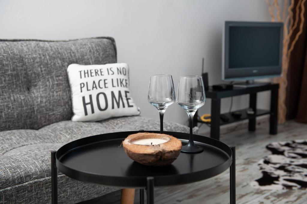 a living room with a table and two wine glasses at Business sky Loft in Sofia