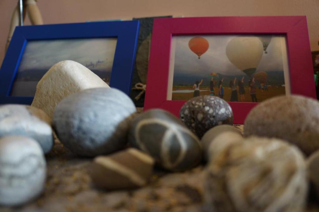 a pile of rocks next to a picture and balloons at HL Sea Homestay in Hualien City