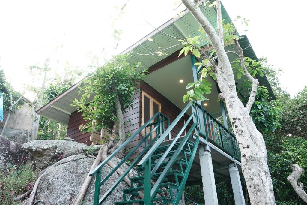 a house with a staircase leading up to it at Salamao Bungalow in Ko Tao
