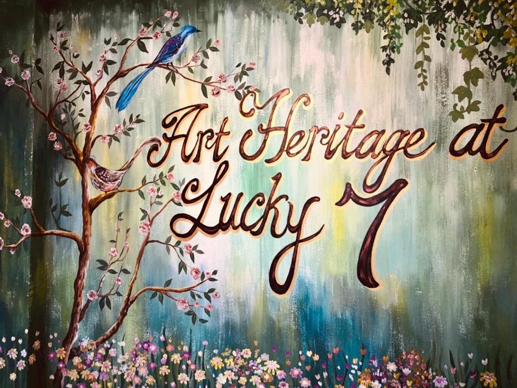 a painting of a bird sitting on a tree at Art Heritage at Lucky 7 in Ipoh