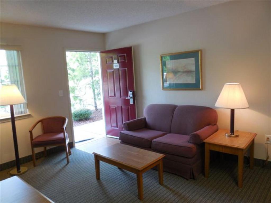 a living room with a couch and a table at Affordable Suites Myrtle Beach in Myrtle Beach