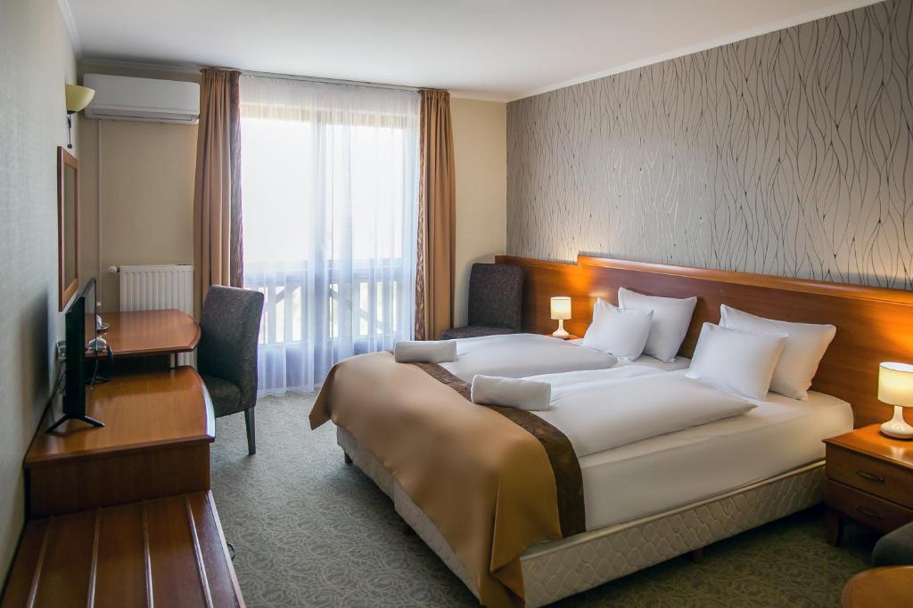 Postel nebo postele na pokoji v ubytování Hotel Narád